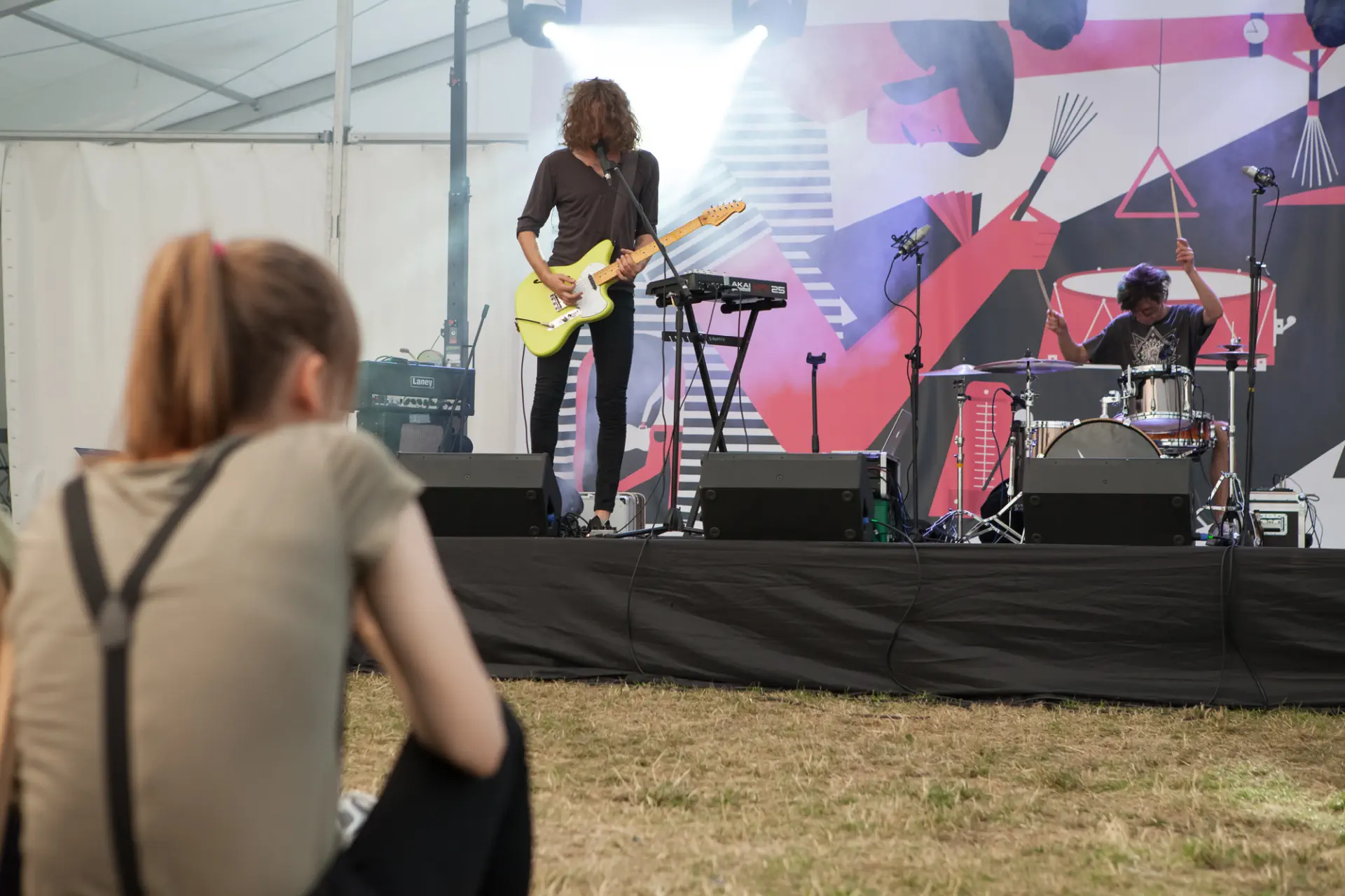 Gitarzysta ma pochyloną głowę nad instrumentem. Gitarzysta ma pochyloną głowę nad instrumentem.