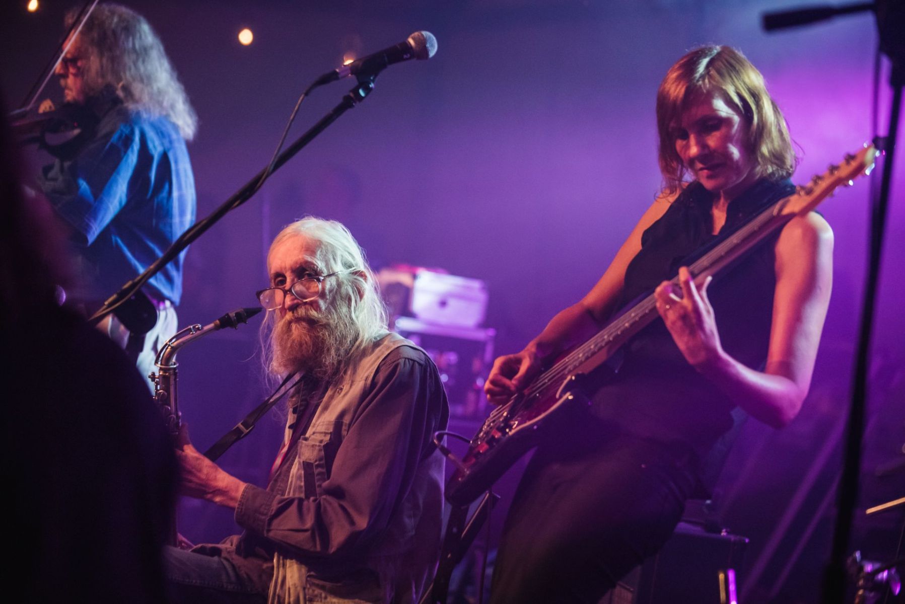 Gitarzystka oraz starszy mężczyzna na scenie.